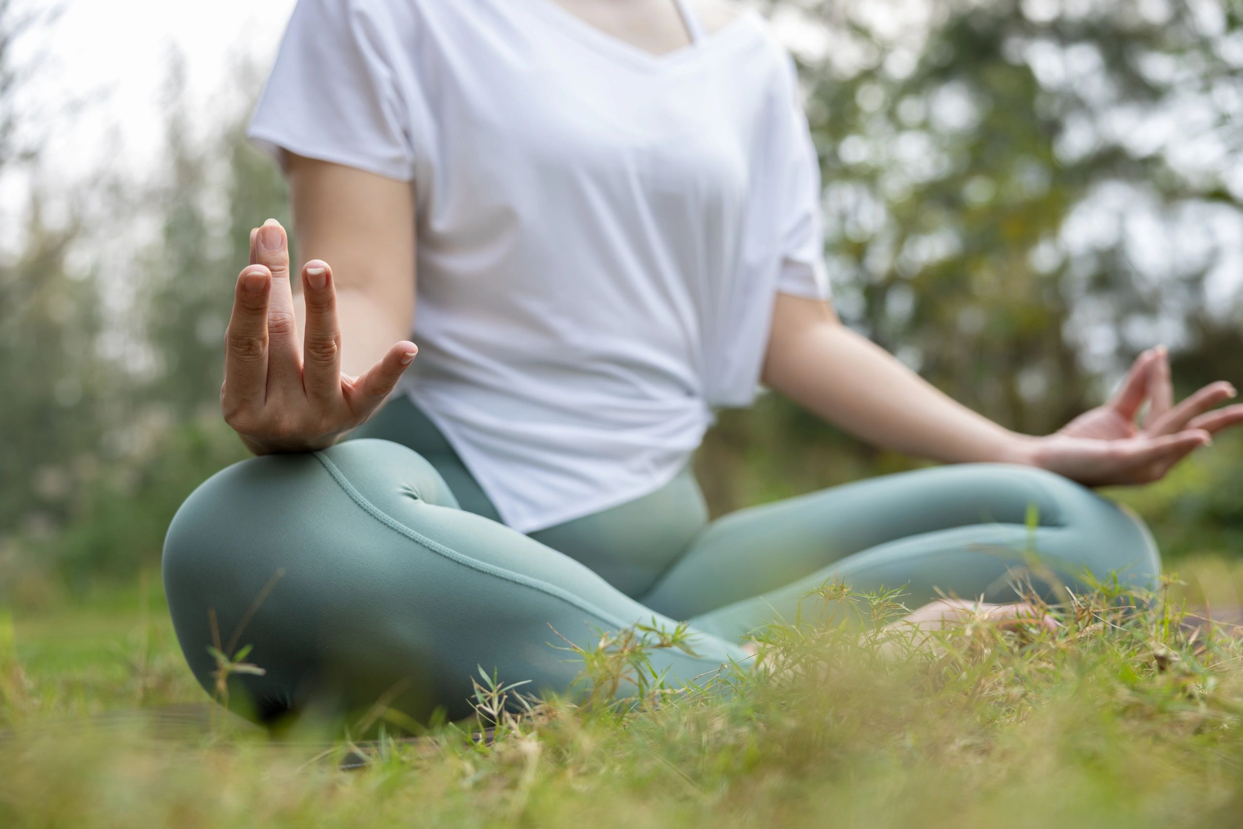 Person meditating outdoors